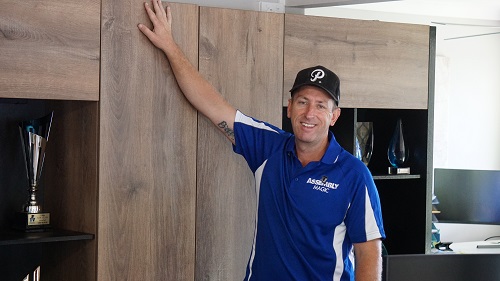 Technician - Ben in front of a newly installed office cabinet