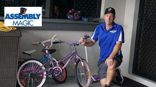 Technician - Ben, with a new bike he assembled. 