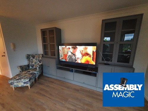 A large wall unit in a living room with Assembly Magic logo in top left corner