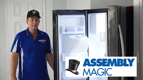 Technician Ben, standing in kitchen next to an open refrigerator