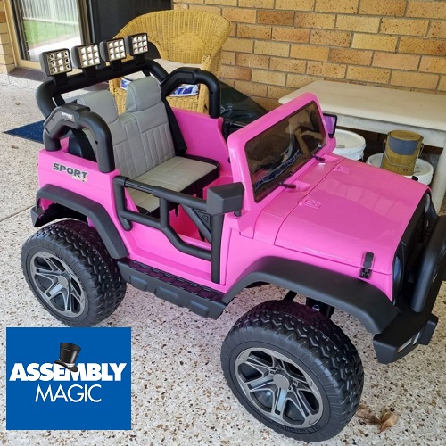A motorised toy car with Assembly Magic logo