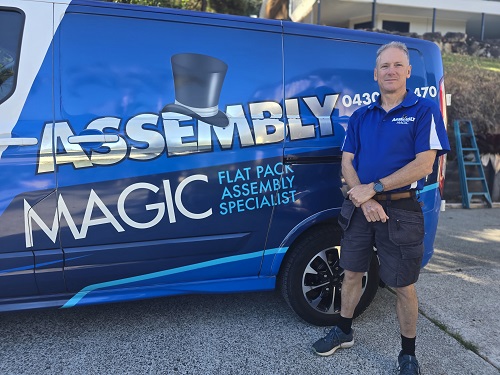 Assembly specialist Robert, standing next to his vehicle.