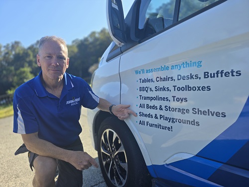Technician - Robert, point at his playground assembly service on the side of his van