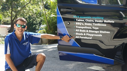 Technician Shaun showing services on door of his van.