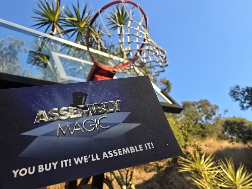 Basketball hoop overlapped by Assembly Magic biz card