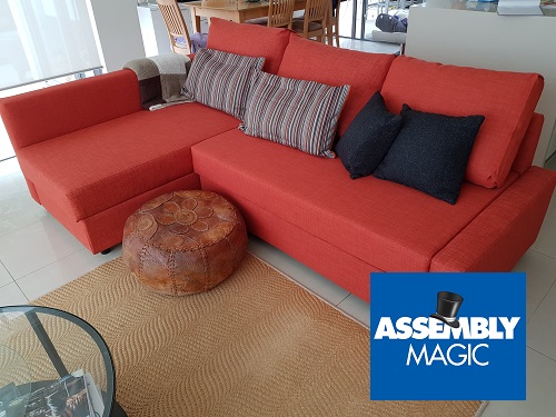 Red lounge suite with Assembly Magic logo in bottom right corner