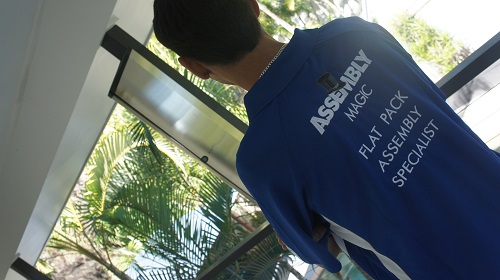 Technician Shaun, showing the back of his Assembly Magic shirt.