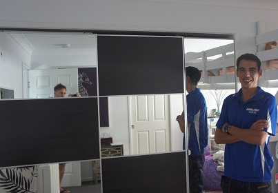 Technician - Shaun in front of a large mirrored wardrobe