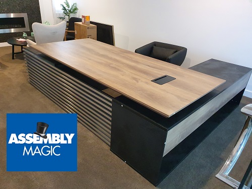 Office desk with Assembly Magic logo in bottom left corner