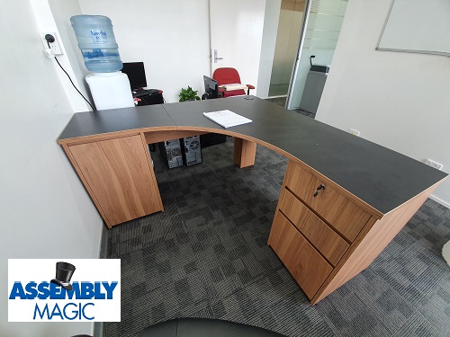 Office furniture relocated by Assembly Magic. Assembly Magic logo in bottom left corner