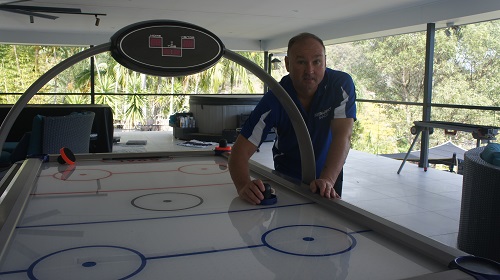 Technician with a newly assembled air hockey table