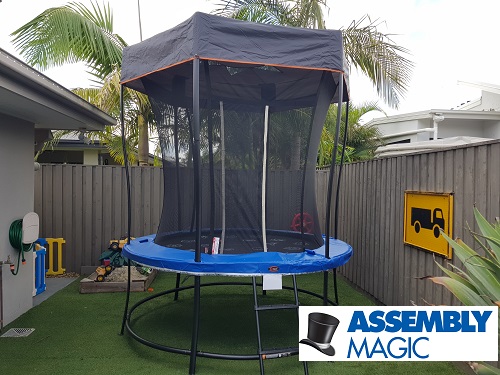 Trampoline with shade cover, assembled by Assembly Magic. Logo in bottom right corner.