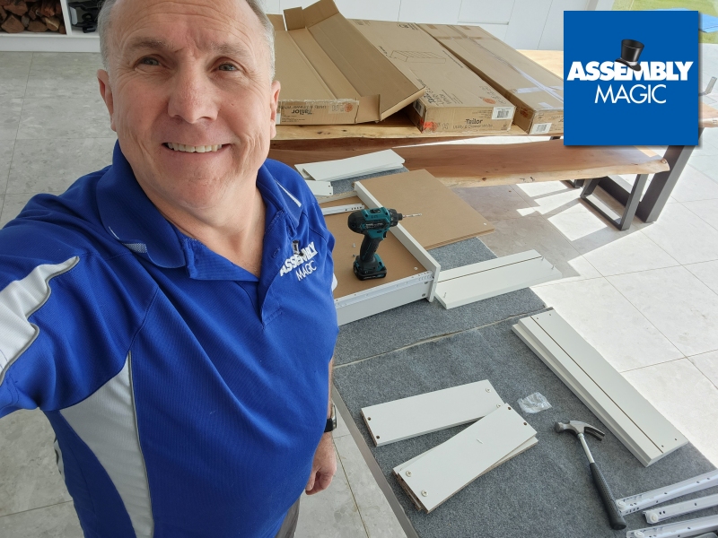 Merv in front of an opened Flat Pack half built on the floor