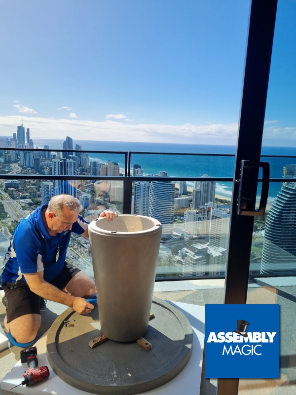 Merv assembly a table on a high rise balcony over looking Surfers paradise buildings