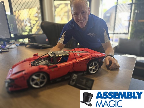 Technician with a Lego car he built. Logo in bottom right corner.